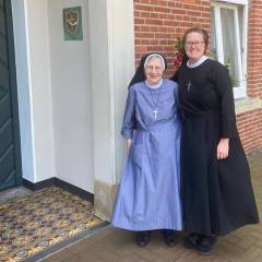 Sr. M. Ignatia with Sr. M. Karolis at the Motherhouse entrance