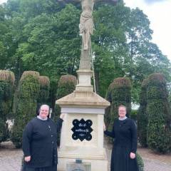 The sisters at the crucifix in the cemetery